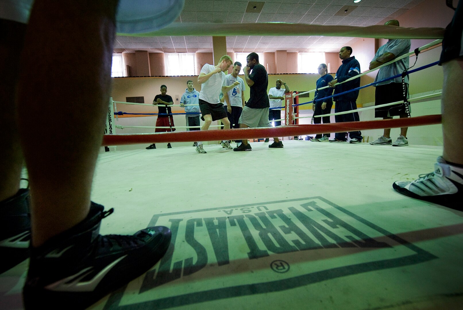 Air Force boxing team hopefuls Jarrett Johnson and James Beck work on delivering body blows while boxing coach Steven Franco oversees the service-wide camp March 23. (U.S. Air Force photo/Senior Airman Christopher Griffin)
