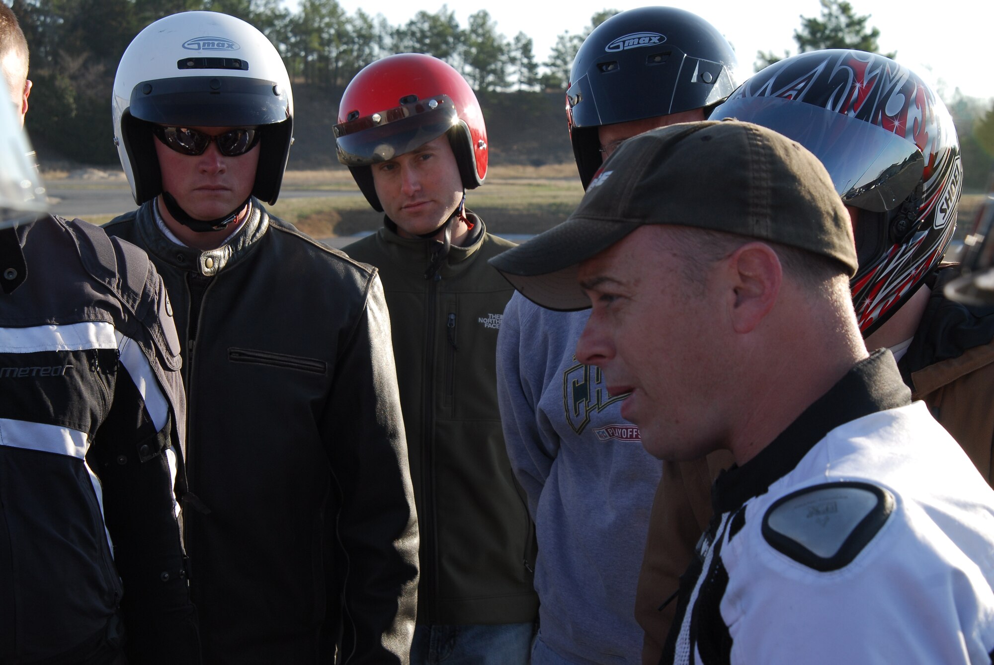 Base personnel discuss motorcycle safety at the Little Rock Air Force Base motorcycle pad, which opened for spring training March 19. The training demonstrates Team Little Rock leader’s commitment to motorcycle rider safety. Base personnel who ride motorcycles must have the MSF or approved state course. (U.S. Air Force photo by Staff Sgt. Juan Torres)