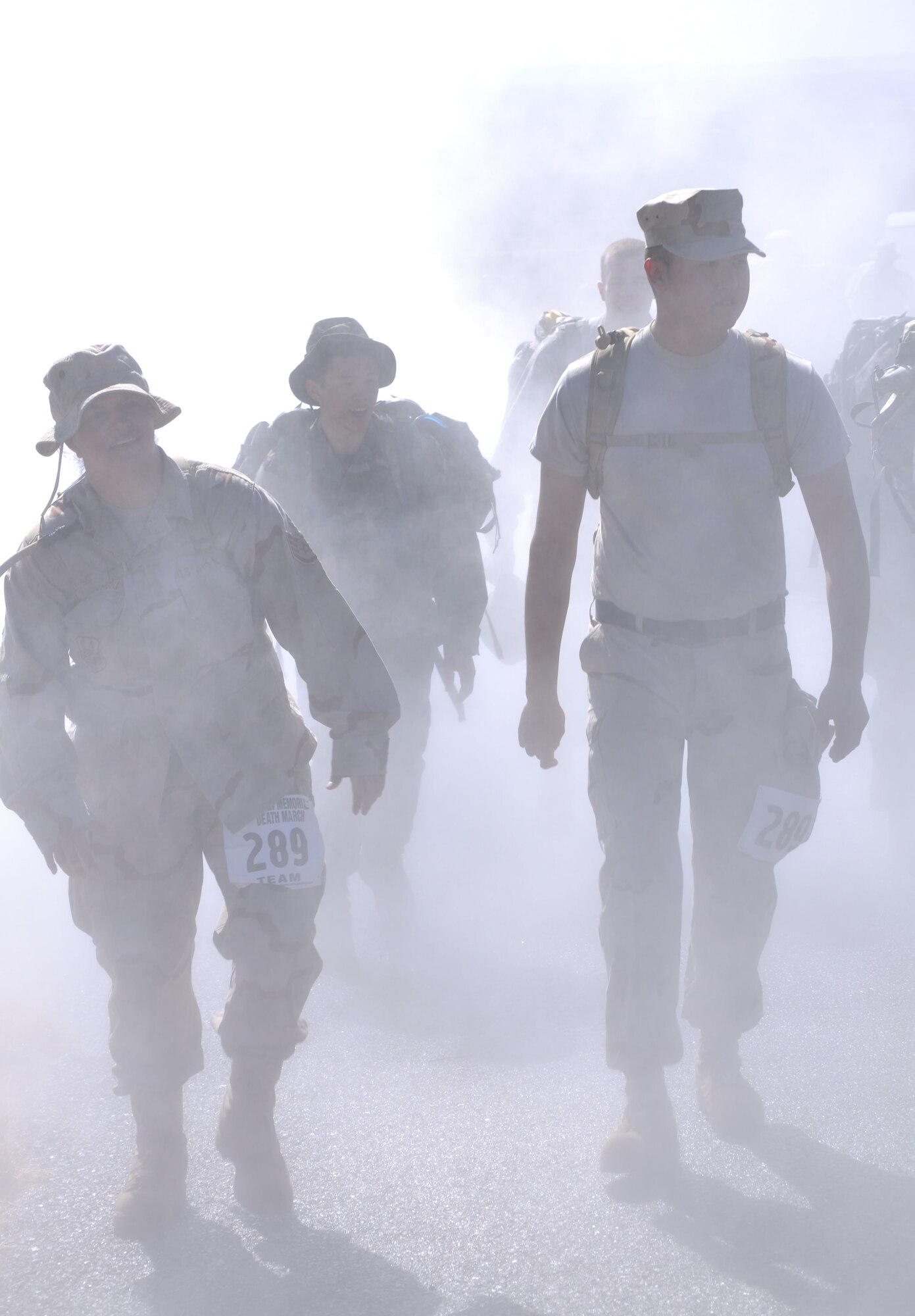 WHITE SANDS MISSILE RANGE, N.M. -- Participants of the 21st Annual Bataan Memorial Death March walk through a cooling mist on the 26.2 mile trail, March 21, 2010. The Bataan Memorial Death March commemorates the Bataan Death March which occurred in the Philippines during World War II. On April 9, 1942, 75,000 Army, Army Air Corps, Navy, Marine and Filipino soldiers were surrendered to Japanese forces. Forced to march 60 miles in the sweltering heat through the Philippine jungles, thousands of soldiers died in transit to prisoner-of-war camps. A record of more than 5,700 military and civilian marchers attended the 21st Annual Bataan Memorial Death March. (U.S. Air Force photo by Airman 1st Class Joshua Turner) (Released)
