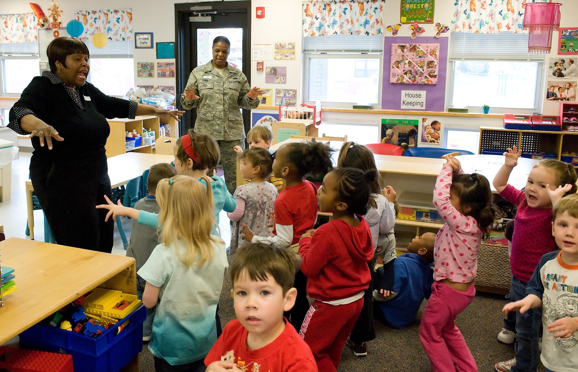 (Left) Patricia Edwards, 436th Force Support Squadron Airman and Family Readiness Center community readiness consultant and Women?s History Month committee member, teaches the children at the Child Development Center how to dance to the teapot song and the itsy-bitsy spider March 25. (U.S. Air Force photo/Jason Minto) 