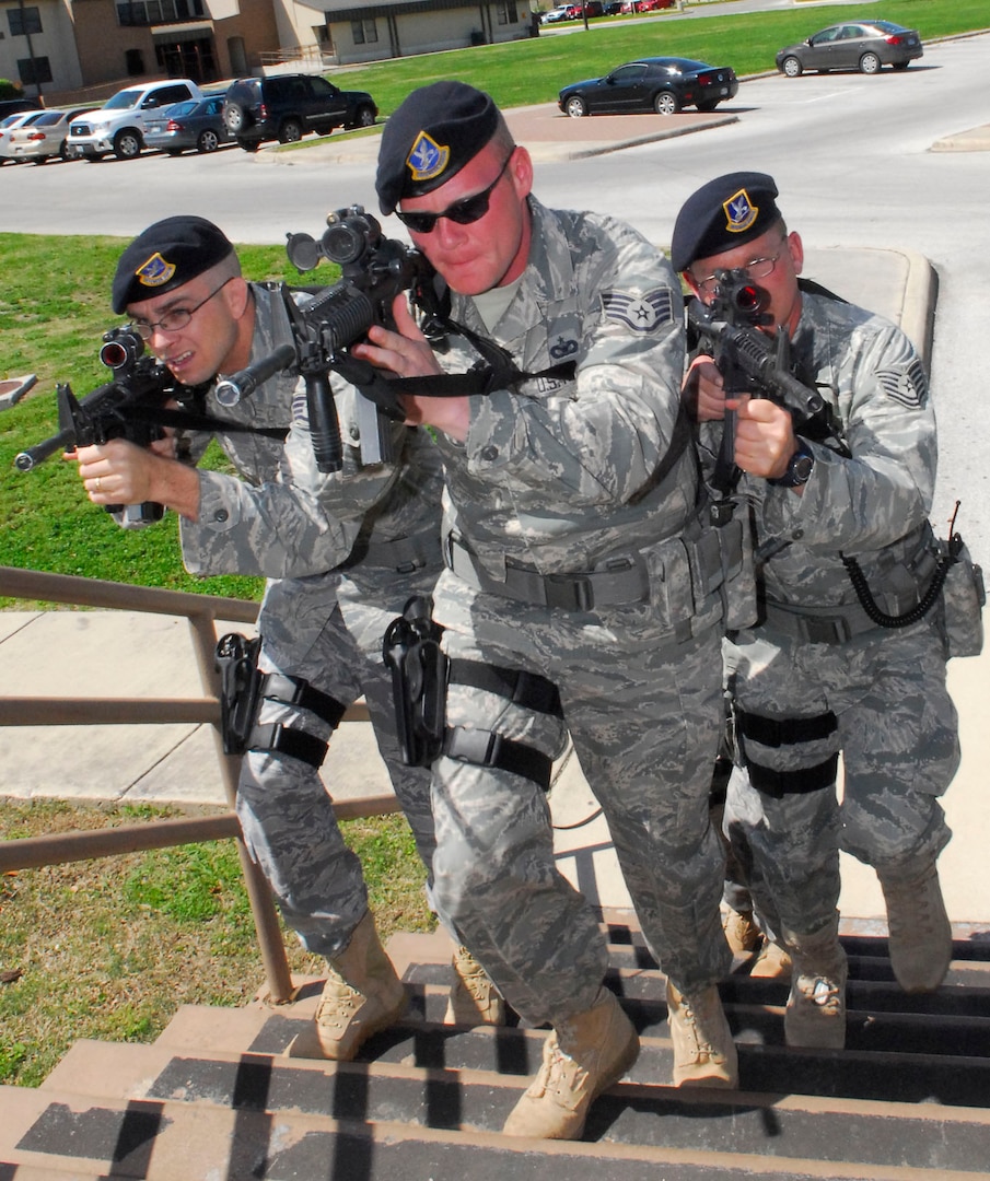(Left to right) Staff Sgt. Glenndon Blue, Staff Sgt. James Leggitt and Tech. Sgt. David Hammond, 802nd Security Forces Squadron, participate in an active shooter training class March 22. The class teaches security forces Airmen how to respond to the dynamic scenario of an active shooter. (U.S. Air Force photo/Alan Boedeker)