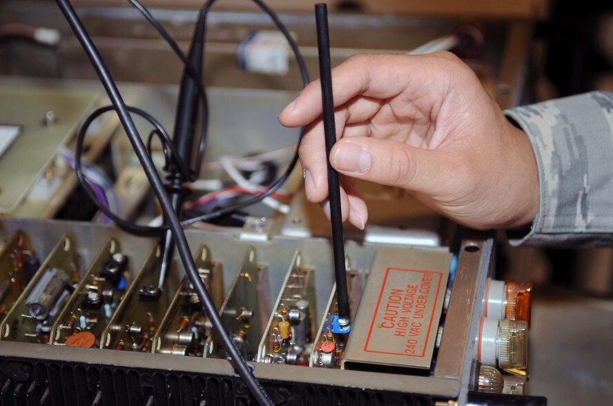 BARKSDALE AIR FORCE BASE, La. -- Airman 1st Class Jeffrey Sales, 2d Communications Squadron airfield systems maintenance technician, tunes a radio transmitter March 23. Airfield systems technicians perform daily, weekly, monthly and other timely preventive maintenance inspections on their equipment to ensure it is functioning smoothly and operating within Air Force standards.  (U.S. Air Force photo by Staff Sgt. John Gordinier)