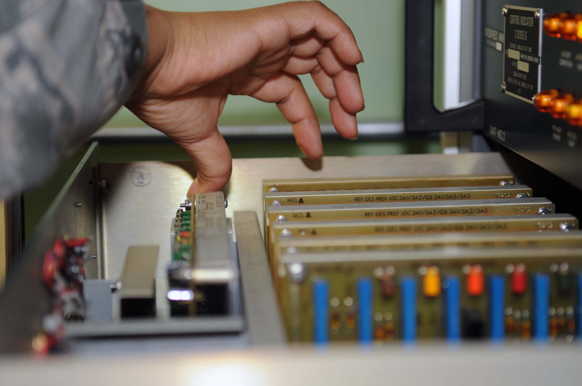 BARKSDALE AIR FORCE BASE, La. -- Staff Sgt. Desiree Jackson, 2d Communications Squadron airfield systems maintenance technician, adjusts the upper-alarm limit for percent of modulation on the 33 Glideslope March 23. This is an 84-day preventive maintenance inspection, which ensures airfield systems are operating effectively and up to Air Force standards.  (U.S. Air Force photo by Staff Sgt. John Gordinier)