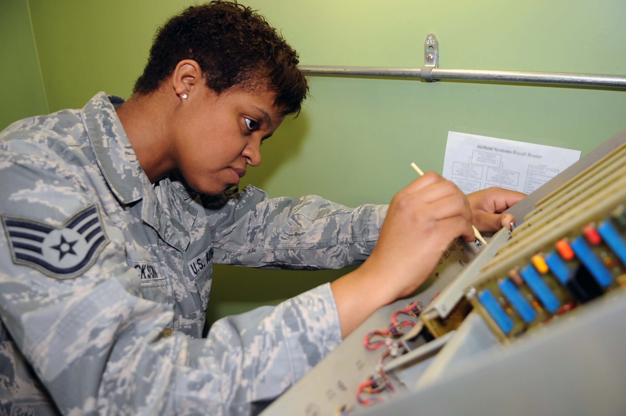 BARKSDALE AIR FORCE BASE, La. -- Staff Sgt. Desiree Jackson, 2d Communications Squadron airfield systems maintenance technician, adjusts the upper-alarm limit for percent of modulation on the 33 Glideslope March 23. This is an 84-day preventive maintenance inspection, which ensures airfield systems are operating effectively and up to Air Force standards.  (U.S. Air Force photo by Staff Sgt. John Gordinier)