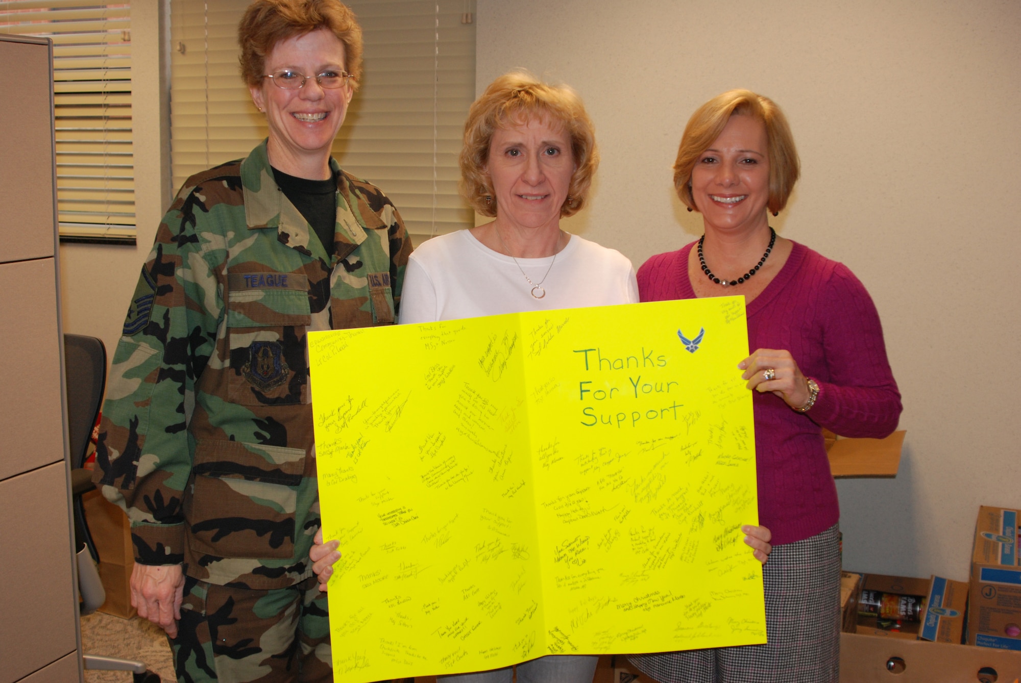Master Sgt. Deb Teague enlists the help of others to help make the Family Readiness office shine.  They help with many events throughout the year, especially during the stressful holidays when families might be separated by a deployment.  (U.S. Air Force photo/Maj. Stan Paregien)