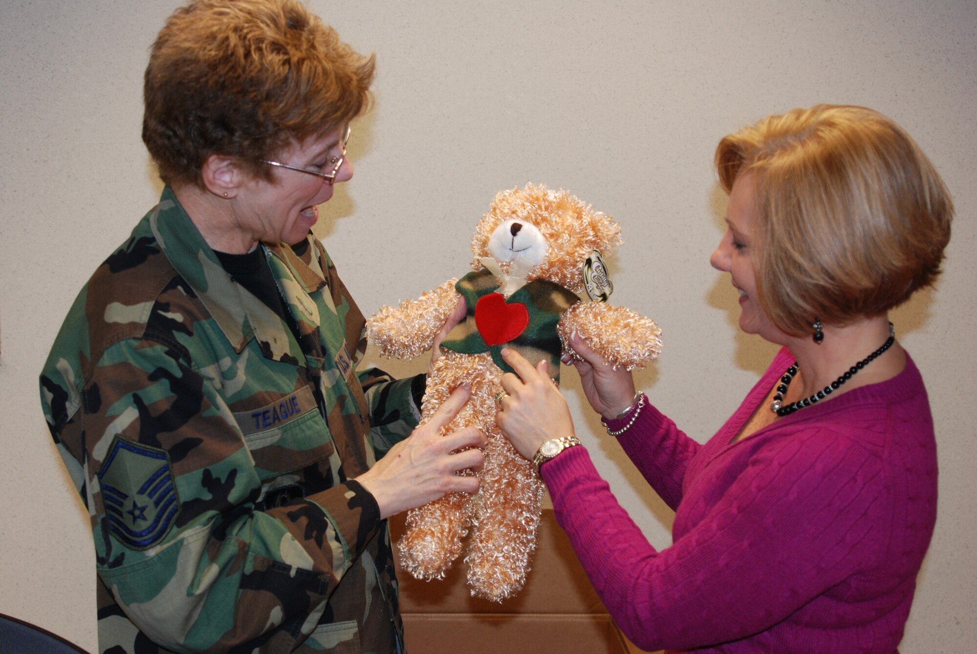 Master Sgt. Deb Teague enlists the help of others like Faith Edwards throughout the 932nd Airlift Wing, to help make the Family Readiness a one stop location when a family member may need assistance.  They give a way food and stuffed animals like this bear to children.  They help with many events throughout the year, especially during the stressful holidays when families might be separated by a deployment.  (U.S. Air Force photo/Maj. Stan Paregien)