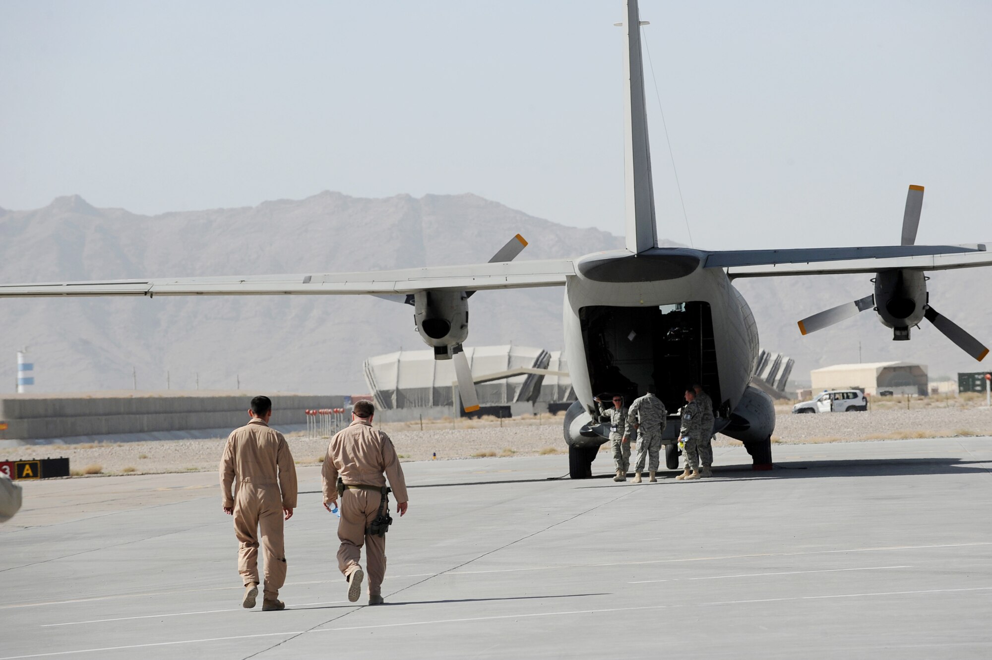 Afghanistan National Army Air Corps 1st Lt. Faiz M. Ramaki and Lt. Col. James Piel walk to a parked ANAAC C-27 Spartan March 24, 2010, at Kandahar Airfield, Afghanistan. Colonel Piel is the 538th Air Expeditionary Advisory Squadron commander and C-27 pilot-mentor. Lieutenant Ramaki is an ANAAC C-27 pilot. (U.S. Air Force photo/Staff Sgt. Manuel J. Martinez)