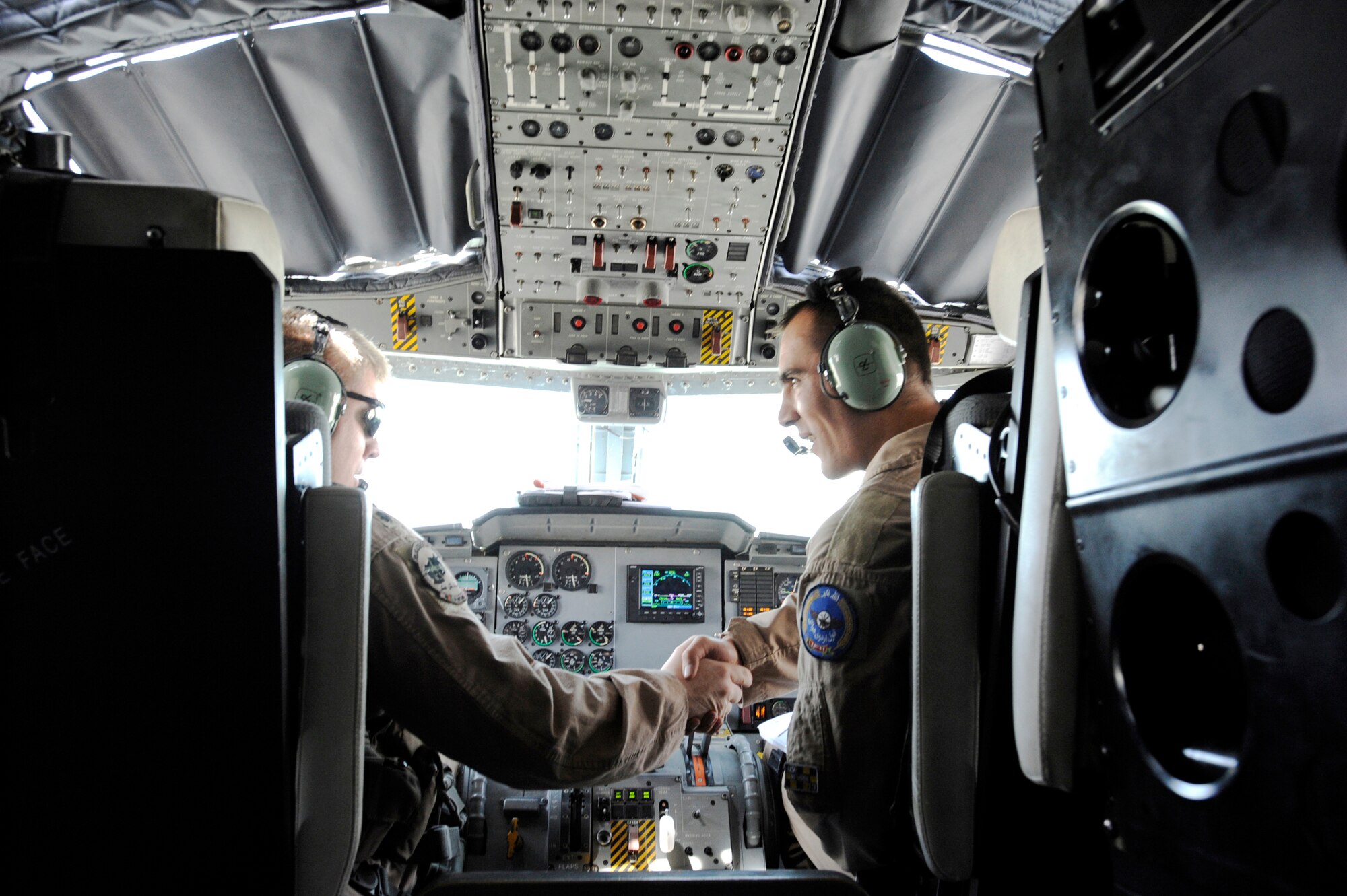 Lt. Col. James Piel (left) and Afghanistan National Army Air Corps 1st Lt. Faiz M. Ramaki shake hands after a successful landing of a C-27 Spartan March 24, 2010, at Kandahar Airfield, Afghanistan. Colonel Piel is the 538th Air Expeditionary Advisory Squadron commander and C-27 pilot-mentor. Lieutenant Ramaki is an ANAAC C-27 pilot. (U.S. Air Force photo/Staff Sgt. Manuel J. Martinez)