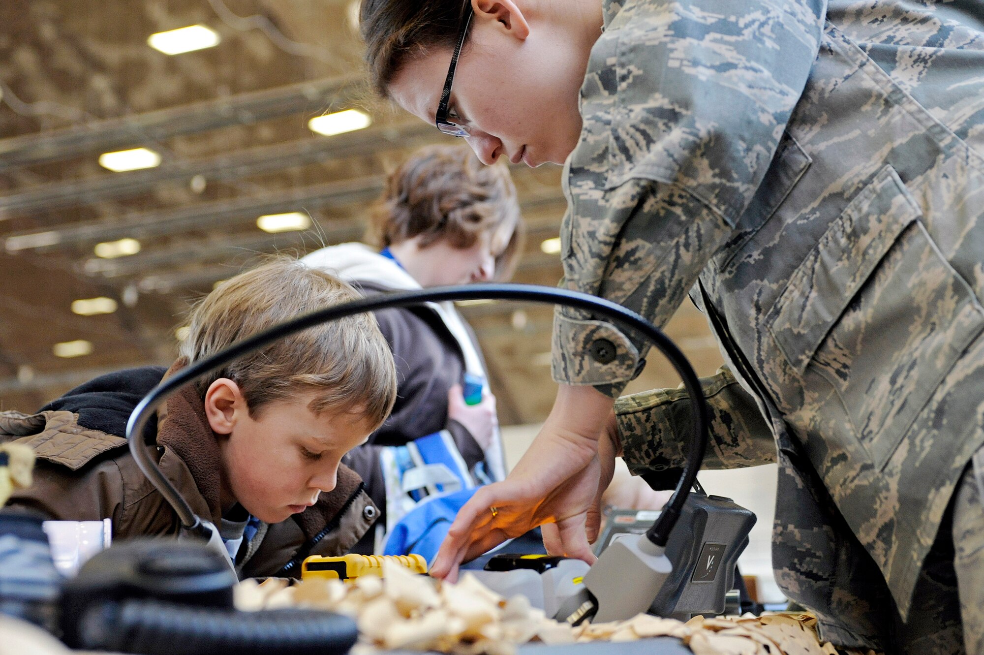 Senior Airman Carolyn Southards shows a military child how an identification kit can verify different substances March 13, 2010, at Ellsworth Air Force Base, S.D. The focus of the event was to give families of Airmen a better understanding of what it means to deploy. Airman Southards is a 28th Civil Engineer Squadron emergency management journeyman. (U.S. Air Force photo/Airman 1st Class Matthew Flynn)