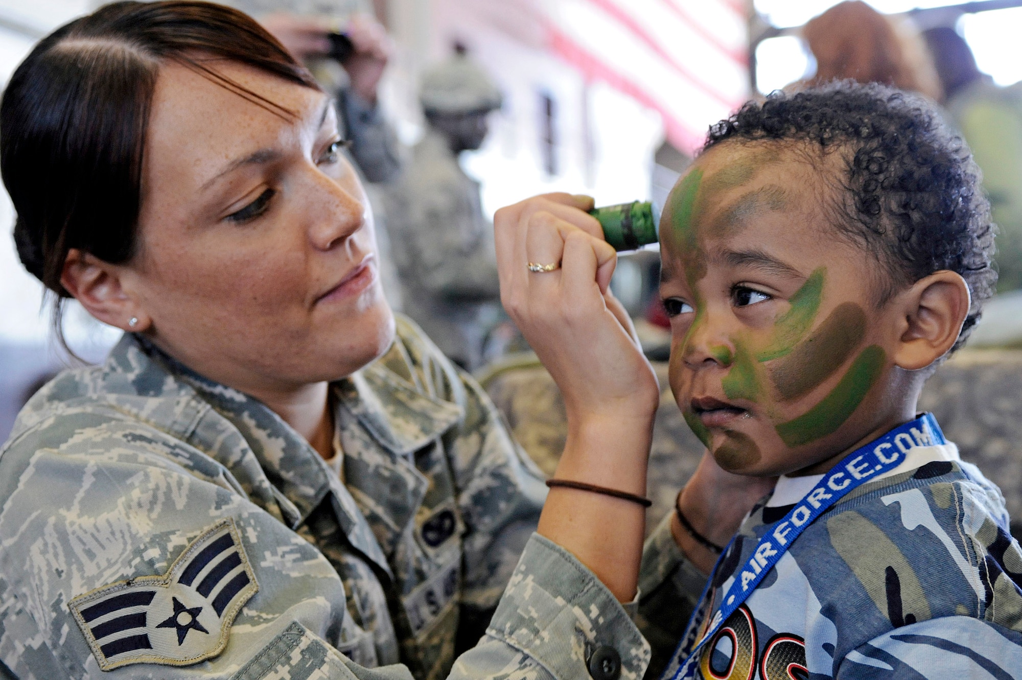 Senior Airman Melanie Allen paints the face of a child during the Kids, Spouses and Teachers Understanding Deployment Operations event March 13, 2010, at Ellsworth Air Force Base, S.D. Airman Allen is a 28th Security Forces Squadron training instructor. (U.S. Air Force photo/Airman 1st Class Matthew Flynn)