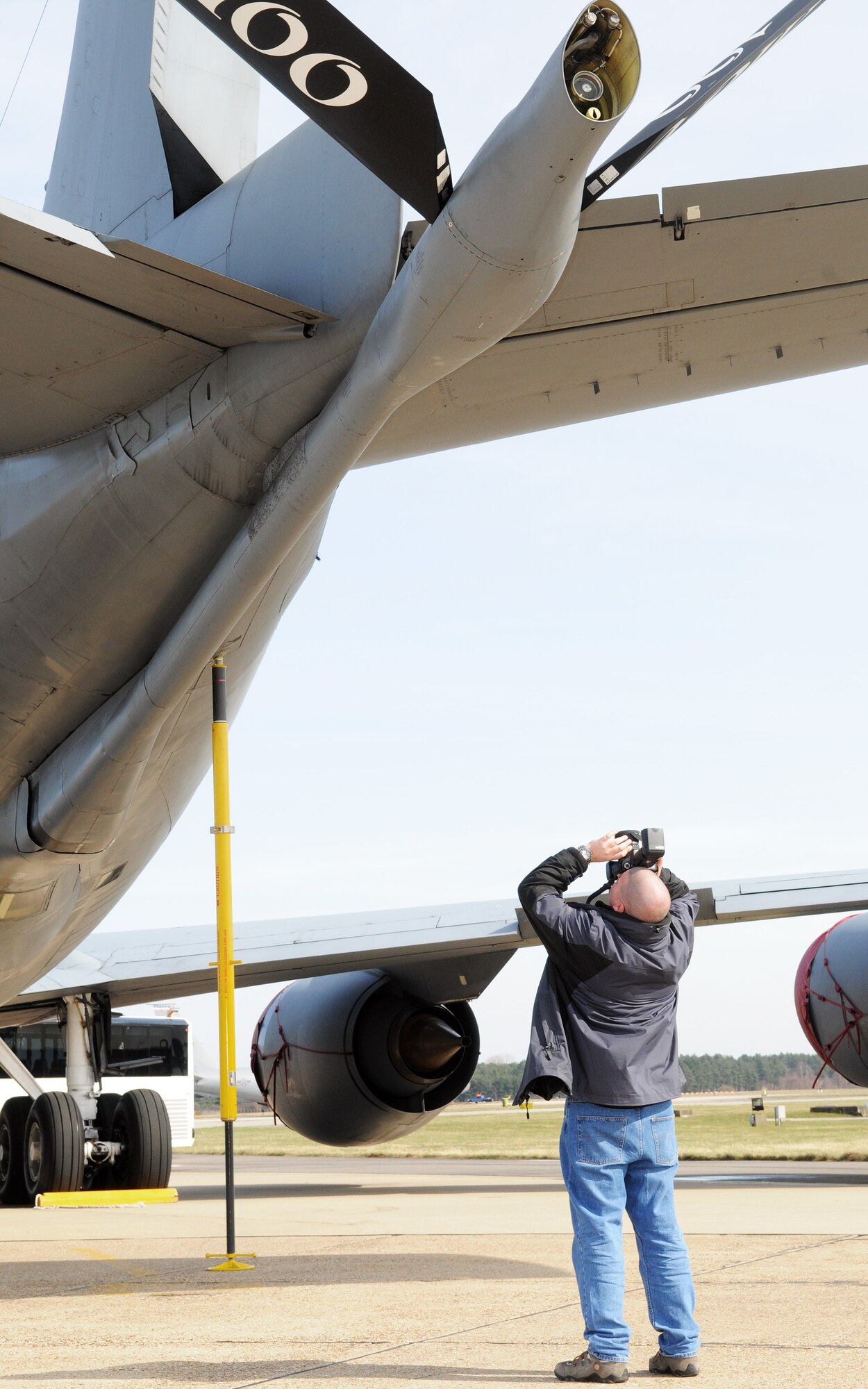 RAF MILDENHALL, England -- Daniel Marshall, an airplane enthusiast, photographs the boom of a 100th Air Refueling Wing KC-135 Stratotanker during a base familiarization tour on the flightline here March 23. Several enthusiasts were invited to join a new program called Spotter Watch that is recruiting "tailspotters," hobbyists who sit outside the base perimeter in designated sites and photograph aircraft, to report suspicious activity to authorities and improve base security. (U.S. Air Force photo/Staff Sgt. Thomas Trower) 