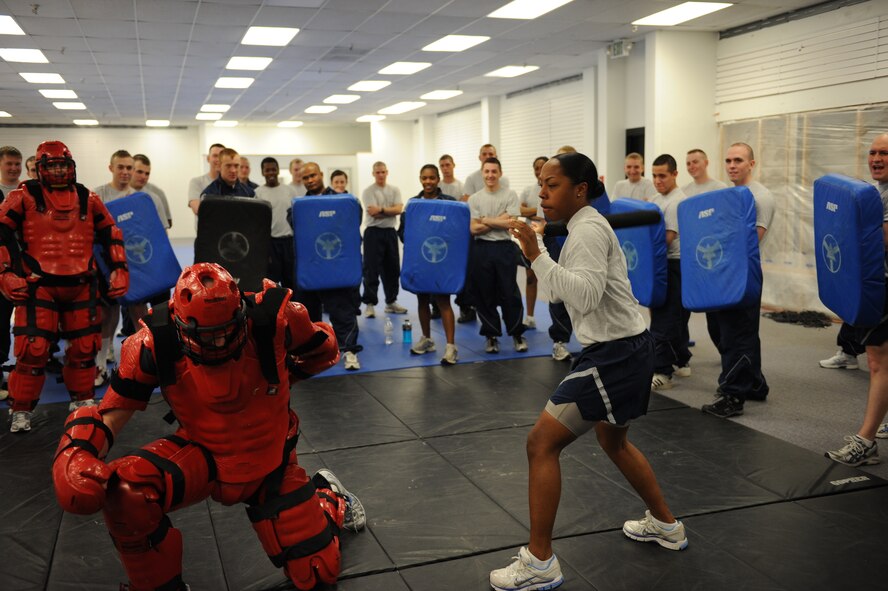 MINOT AIR FORCE BASE, N.D. -- Staff Sgt. Nakami Liddell, 5th Security Forces Squadron security forces journeyman, uses the techniques she just learned in the baton training class to take down her “attacker” at Minot Air Force Base March 17. The 5th SFS Airmen attend this weekly training to learn how to defend themselves against an attacker. The instructors wear protective padding while the students put the skills they have learned to the test. (U.S Air Force photo by Staff Sgt. Stacy Moless)