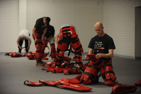 MINOT AIR FORCE BASE, N.D. -- Tech. Sgt. Bradley Tarbox, an instructor from the 5th Security Forces Squadron, suits up in preparation for his baton training class at Minot Air Force Base March 17. The 5th SFS Airmen attend this weekly training to learn how to defend themselves against an attacker. The instructors wear protective padding while the students put the skills they have learned to the test. (U.S Air Force photo by Staff Sgt. Stacy Moless)