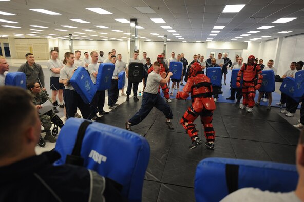 MINOT AIR FORCE BASE, N.D. -- Members of the 5th Security Forces Squadron participate in baton training at Minot Air Force Base March 17. The 5th SFS Airmen attend this weekly training to learn how to defend themselves against an attacker. The instructors wear protective padding while the students put the skills they have learned to the test. (U.S Air Force photo by Staff Sgt. Stacy Moless)