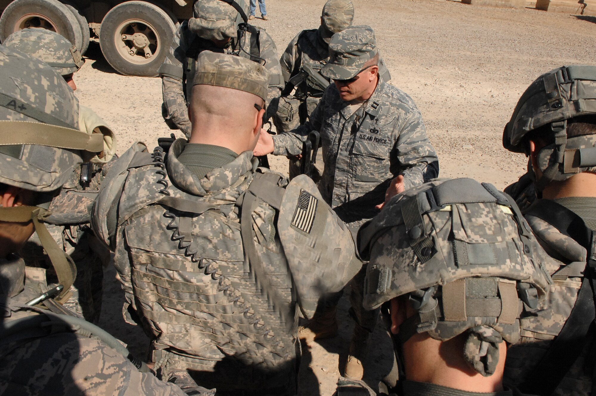 Chaplain (Capt) Steve Fisher, 732nd Air Expeditionary Group chaplain, leads a team in prayer before they rolled out on an outside-the-wire mission. The chaplain team visited more than 100 Airmen to provide pastoral access and care for Joint Expeditionary Tasking Airmen. (U.S. Air Force photo/ Airman 1st Class Allison M. Boehm/Released).