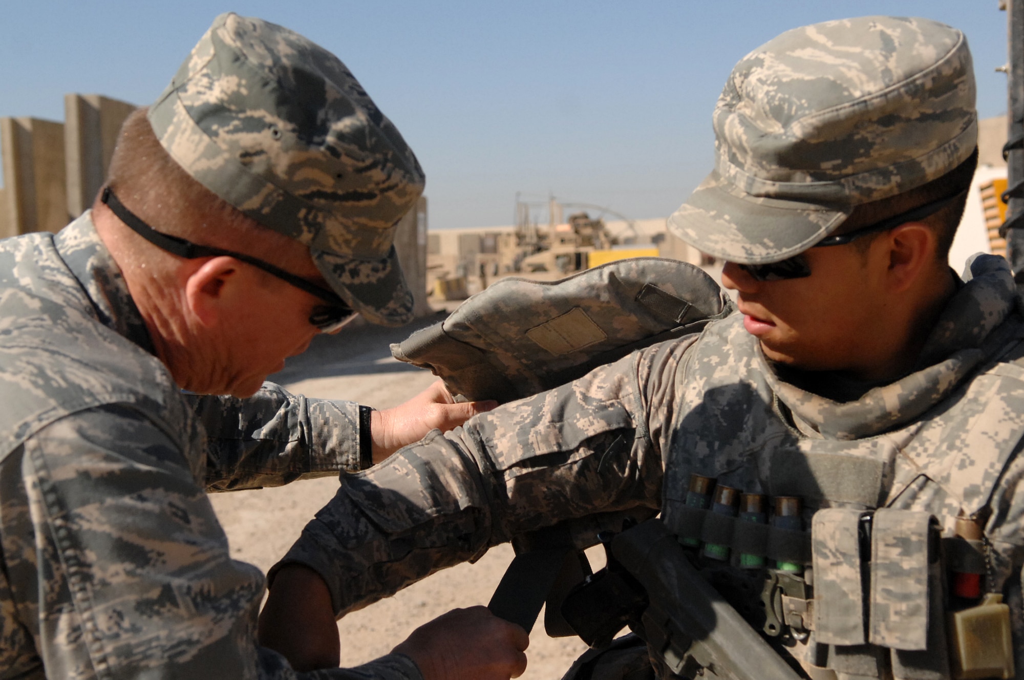 Chaplain (Capt.) Steve Fisher, 732nd Air Expeditionary Group chaplain, helps Airman 1st Class Josue Tello, 732nd AEG Security Forces Squadron vehicle gunner, finish securing his body armor before leaving base on a mission outside-the-wire. Chaplain Fisher visited more than 100 Airmen while on his mission to provide pastoral access and care for Joint Expeditionary Tasking Airmen. (U.S. Air Force photo/ Airman 1st Class Allison M. Boehm/Released)