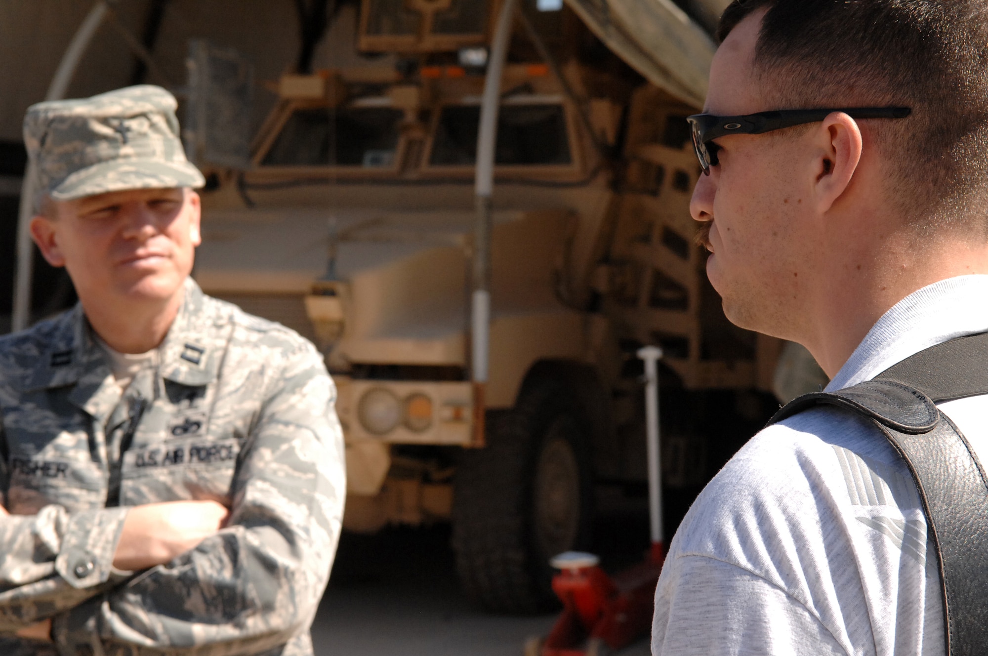 Chaplain (Capt) Steve Fisher, 732nd Air Expeditionary Group chaplain, talks with Senior Airman David Kelly, 732nd AEG Security Forces Squadron vehicle driver, while on a mission to Camp Stryker, in which he visited Joint Expeditionary Tasking Airmen. Among ensuring he and his family were alright, Chaplain Fisher also made sure Airman Kelly had adequate means of communication with loved ones back home. (U.S. Air Force photo/ Airman 1st Class Allison M. Boehm/Released)