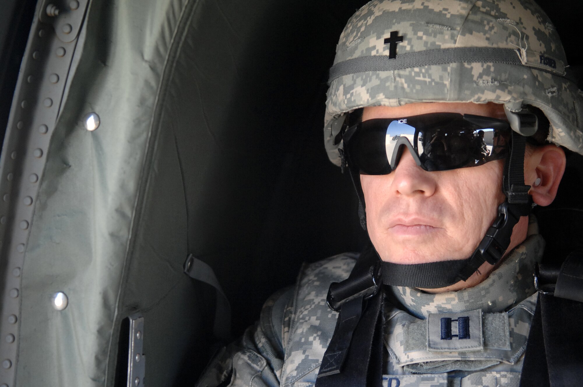 Chaplain (Capt.) Steve Fisher, 732nd Air Expeditionary Group chaplain, gazes out the window of a Blackhawk en route to Baghdad International Airport. Chaplain Fisher visited more than 100 Airmen while on his mission to provide pastoral access and care to Joint Expeditionary Tasking Airmen at remote locations. (U.S. Air Force photo/ Airman 1st Class Allison M. Boehm/Released)