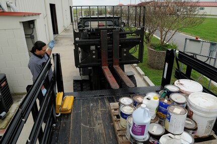 Erik Christianson, Randolph Air Force Base's Hazardous Wase Facility manager, guides Harmin Aguilera to successfully pick up a pallet of hazardous chemicals for proper disposal at their facility. (U.S. Photo by Steve White)