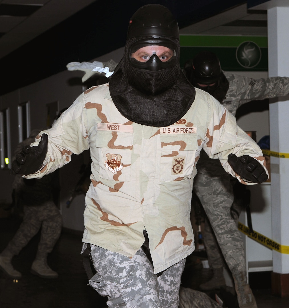 Senoir Airman Robert West of the 902nd Security Forces Squadron at Randolph Air Force Base, TX, flees the scene during security forces Active Shooter Training held in the old Base Exchange facility at Randolph March 24, 2010.  (U.S. Air Force photo by Don Lindsey)