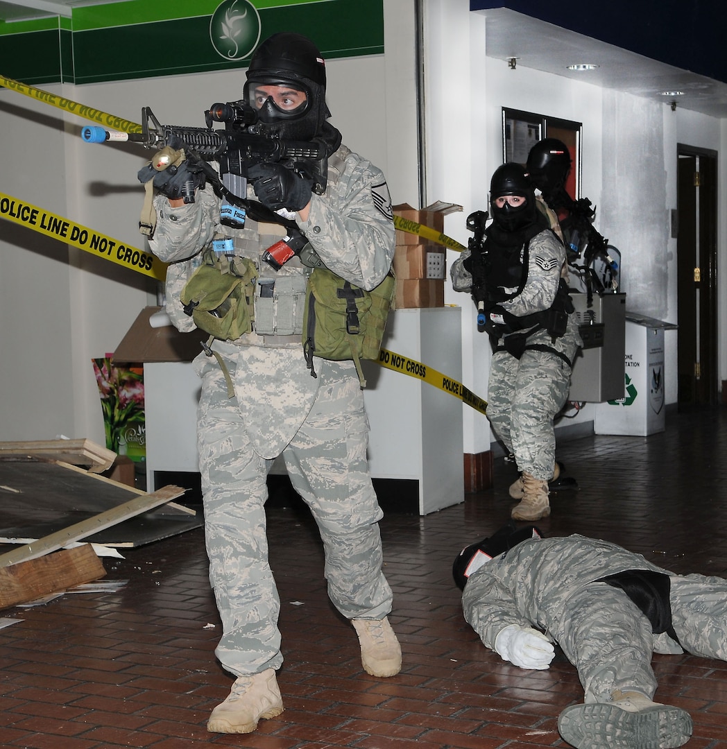 Master Sgt. Antonio Rodriguez, left, of the 902nd Security Forces Squadron at Randolph Air Force Base, TX, clears the path for other personnel to follow after securing the area in the old Randolph Base Exchange facility during Active Shooter Training March 24, 2010.  (U.S. Air force photo by Don Lindsey)