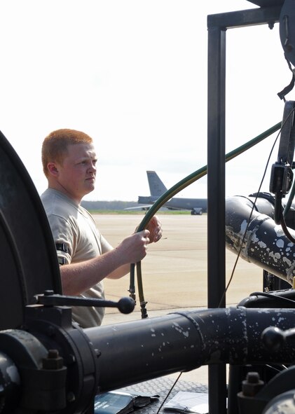 BARKSDALE AIR FORCE BASE, La. – Airman Alex Bellerud, 2d Logistics Readiness Squadron, rolls the sensing lines back on the refueling truck March 24. There are two sensing lines, air and fuel which allow the truck to actually pump fuel into the B-52H Stratofortress. (U.S. Air Force photo by Senior Airman Alexandra Longfellow) (RELEASED)