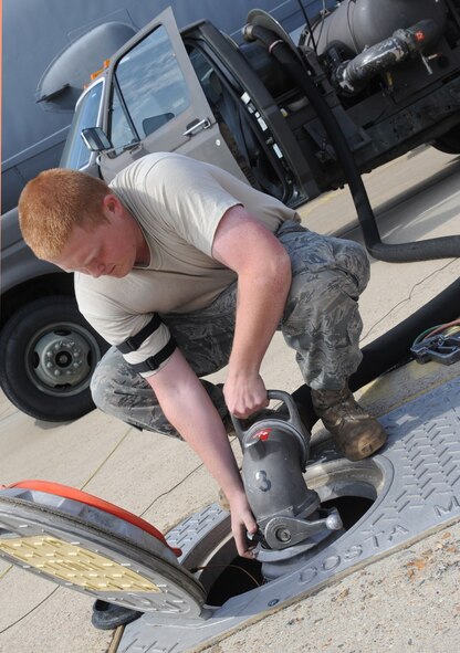 BARKSDALE AIR FORCE BASE, La. – Airman Alex Bellerud, 2d Logistics Readiness Squadron, attaches the fuel nozzle to a hydration system from one of the four operating fuel tanks March 24. Two of Barksdale’s fuel tanks hold up to 1.6 million gallons of fuel as the other two hold up to 1.2 million gallons. (U.S. Air Force photo by Senior Airman Alexandra Longfellow) (RELEASED)