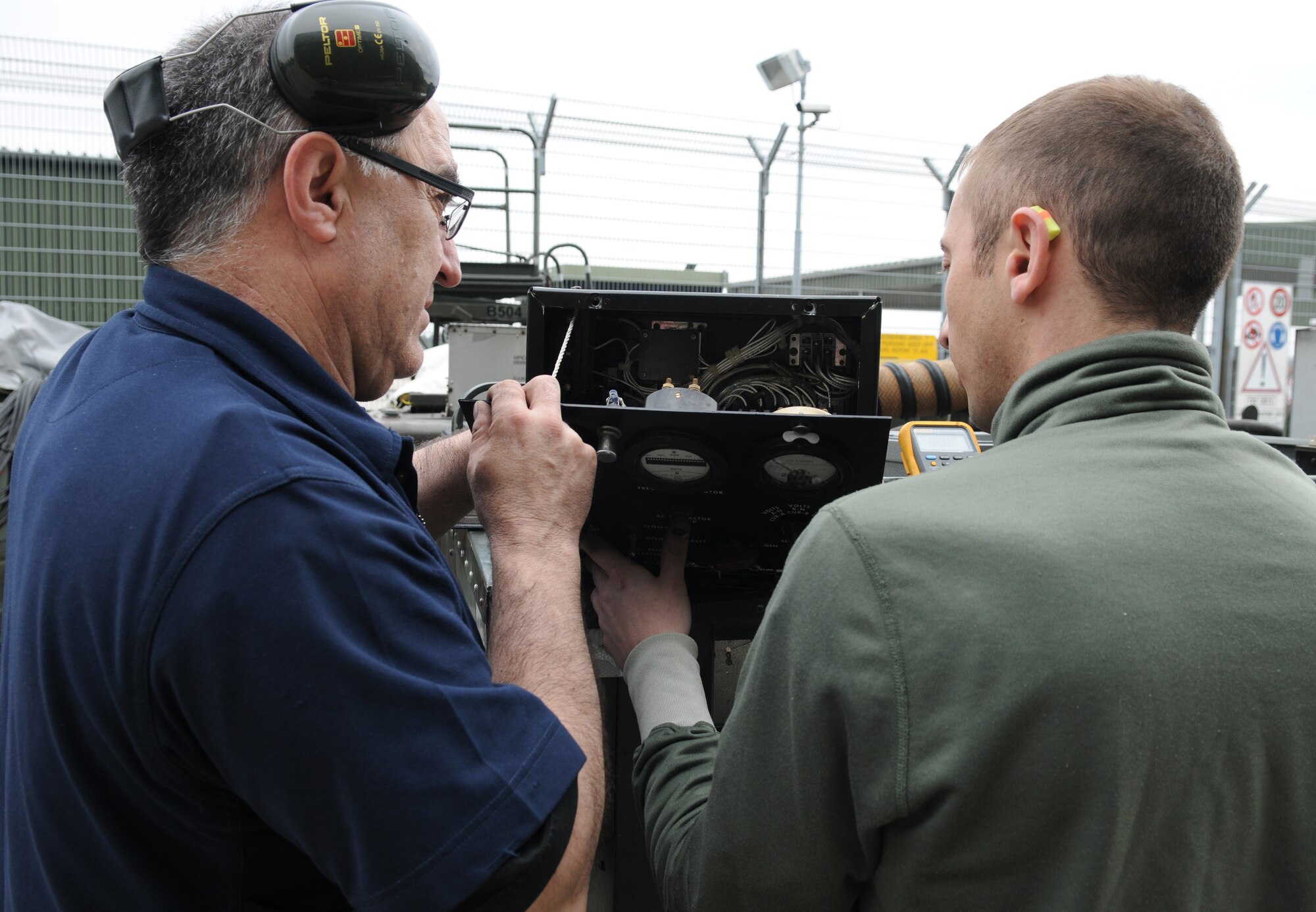 NATO AIR BASE GEILENKIRCHEN, Germany – Senior Airman Michael Miller, NATO E-3A Airborne Early Warning and Control force component aerospace ground equipment journeyman, performs generator maintenance with Fernando Garcia, a Spanish equipment maintenance specialist, at a hangar March 19. The E-3A Component is made of 15 nations and is NATO’s only multinational operational flying unit. (U.S. Air Force photo/Senior Airman Nathanael Callon)
