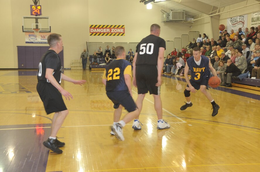 BELLEVUE, Neb. - Team Navy's Charlie Drey drives towards the hoop during the U.S. Strategic Command Army Navy basketball game March 19 at Bellevue University's Gordon Lozier Athletic Center. Army beat Navy with a final score of 82 - 71. U.S. Air Force photo by Dan Rohan
