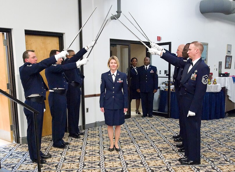 Master Sgt. Valerie Harwood, 512th Airlift Control Flight, is one of 29 senior NCOs who walked through a sword cordon before being inducted into the senior NCO corps March 6 at the Landings. U.S. Air Force photo/Brianne Zimny)