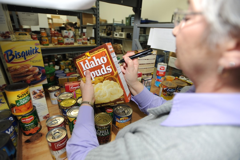 WHITEMAN AIR FORCE BASE,Mo. - Sandi Williams, 509th Force Support Squadron community readiness consultant at the Airman Family Readiness Center, stocks the shelves of the food pantry, March 24, 2010. The food pantry is located in the AFRC , and is available to Airmen in need.  (U.S. Air Force photo By Airman 1st Class Carlin Leslie)



