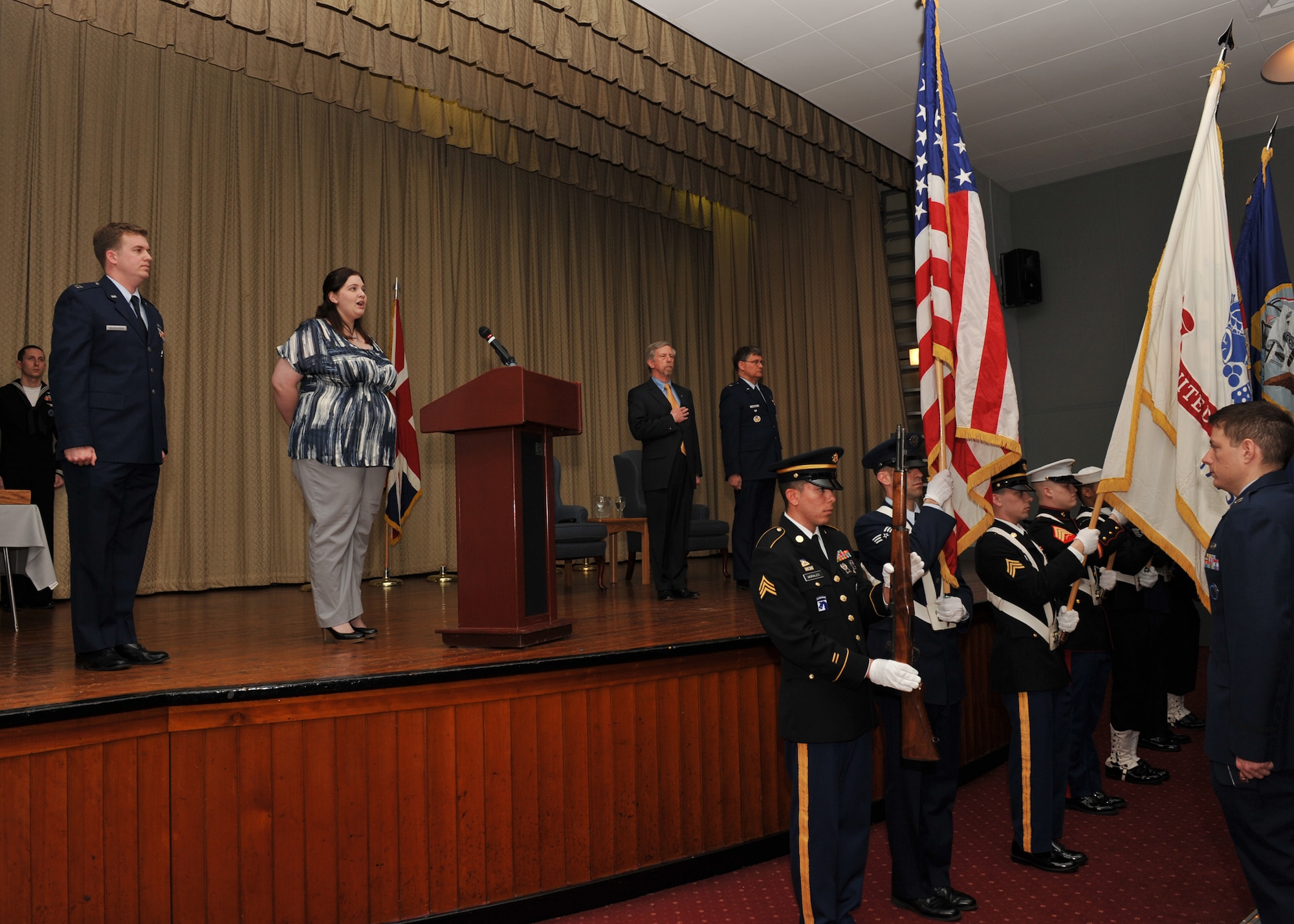Victoria Stiegel sings the National Anthem during the retirement ceremony for her father, Colonel Robert G. Stiegel, on Mar. 18, 2010.  (Photo by U.S. Air Force Staff Sgt. Javier Cruz)