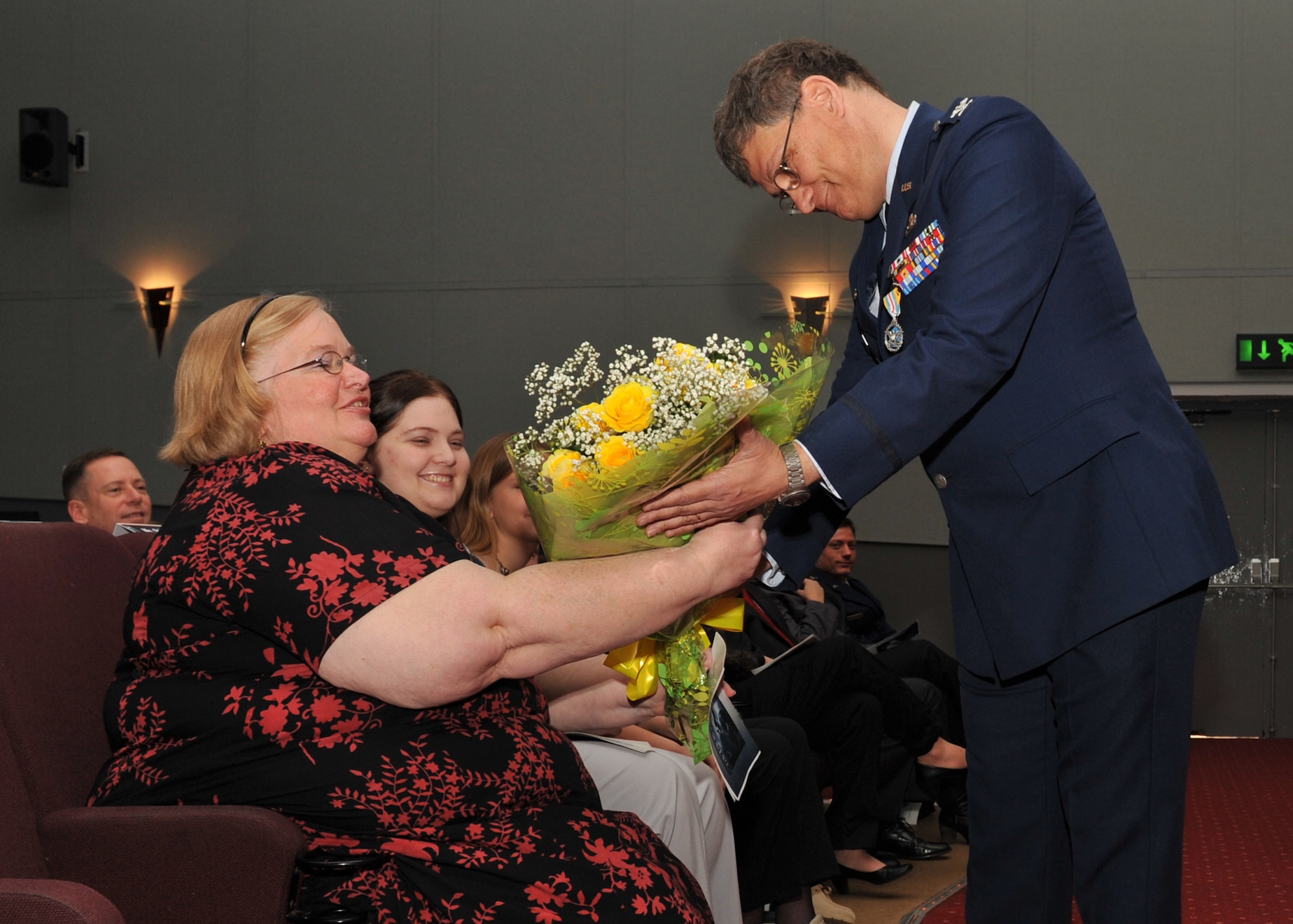 U.S. Air Force Col. Robert G. Stiegel presents flowers to his wife Mary during his retirement ceremony on Mar. 18, 2010.   (Photo by U.S. Air Force Staff Sgt. Javier Cruz)
