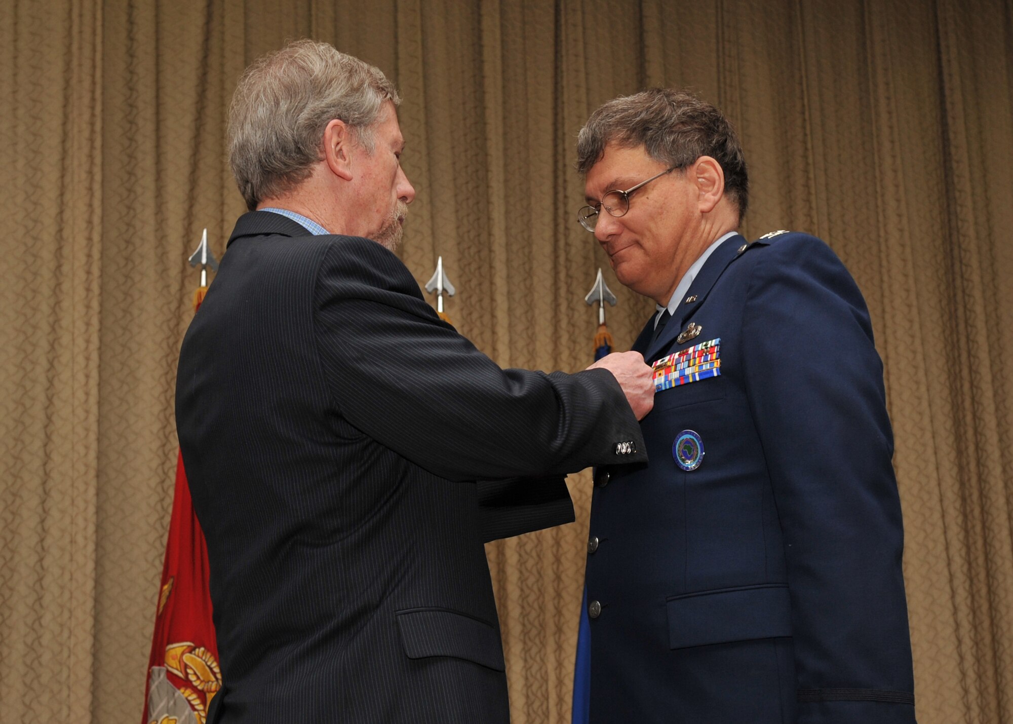 Mr. Terrance Ford, Director, Intelligence and Knowledge Development for U.S. Africa Command, pins the Defense Superior Service Medal on U. S. Air Force Col. Robert G. Stiegel during his retirement ceremony on Mar. 18, 2010.  (Photo by U.S. Air Force Staff Sgt. Javier Cruz)