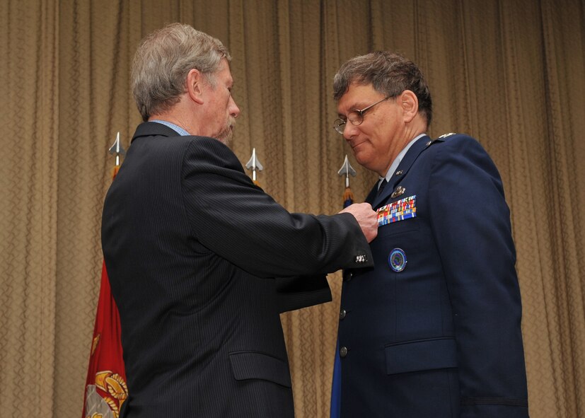 Mr. Terrance Ford, Director, Intelligence and Knowledge Development for U.S. Africa Command, pins the Defense Superior Service Medal on U. S. Air Force Col. Robert G. Stiegel during his retirement ceremony on Mar. 18, 2010.  (Photo by U.S. Air Force Staff Sgt. Javier Cruz)