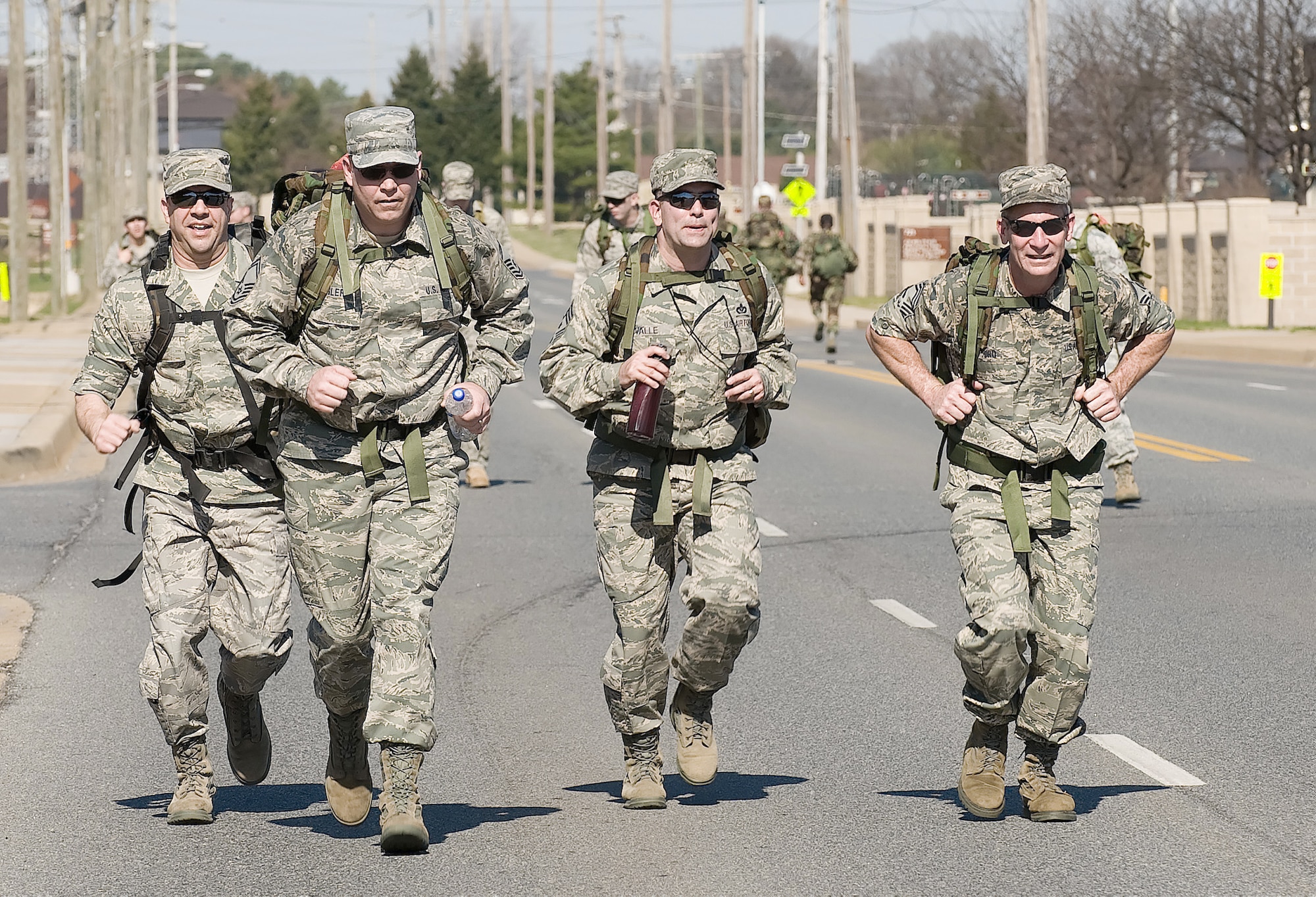 Chief Master Sgt. David Fish (left), and Senior Master Sgt. James Segler (second from left) join other senior NCO's during the 436th Security Forces Squadron's 11th Annual Ruck March held March 20, 2010, at Dover Air Force Base, Del. The annual 6.2-mile march is a fundraiser to honor the veterans of the Korean War who fought in the Battle of the Chosin Reservoir. Chief Fish is the Air Force Mortuary Affairs Operations Center enlisted manager, and Sergeant Segler is the AFMAO superintendent. (U.S. Air Force photo/Jason Minto)