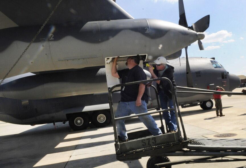 Todd Zoellner and Gary Langley perform a refueling pod inspection on the final MC-130W Combat Spear. U. S. Air Force photo by Sue Sapp