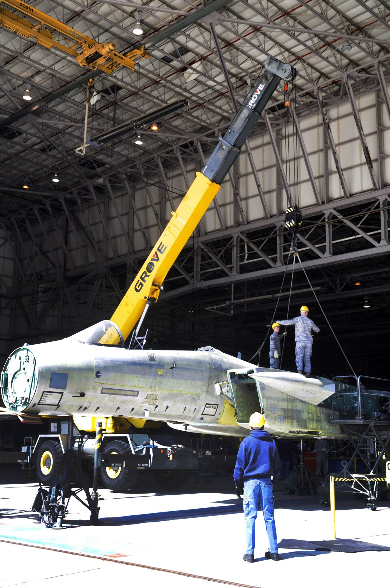 The  fuselage of the F-15 is lifted off jacks before it is loaded onto a flatbed trailer. U. S. Air Force photo by Sue Sapp