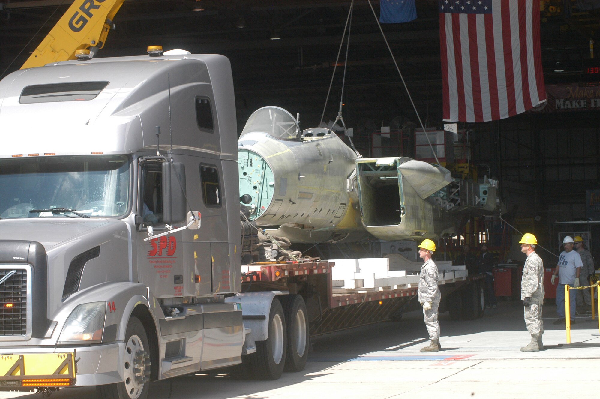 A flatbed trailer is backed under the  fuselage of the F-15. The F-15 aircraft will undergo fatigue testing at the Boeing facility in St. Louis, Mo. U. S. Air Force photo by Sue Sapp