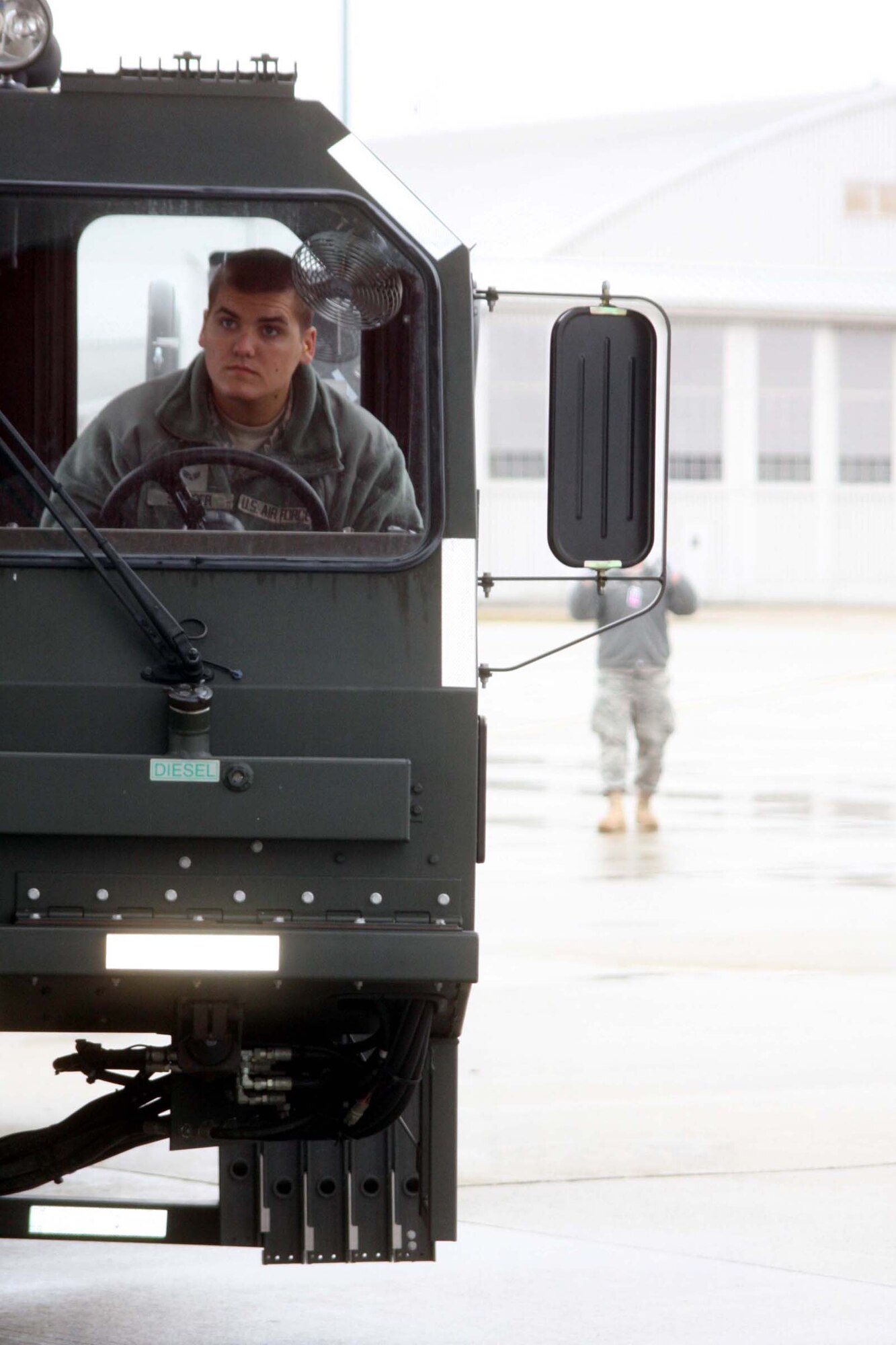 WRIGHT-PATTERSON AIR FORCE BASE, Ohio – Senior Airman Chris Spencer, watches his guide, Staff Sgt. Alex Peiffer, both from the 87th Aerial Port Squadron, closely while driving next to a C-130 Hercules that his unit will be loading cargo onto during the March 14 unit training assembly.  (U.S. Air Force photo/Staff Sgt. Amanda Duncan)