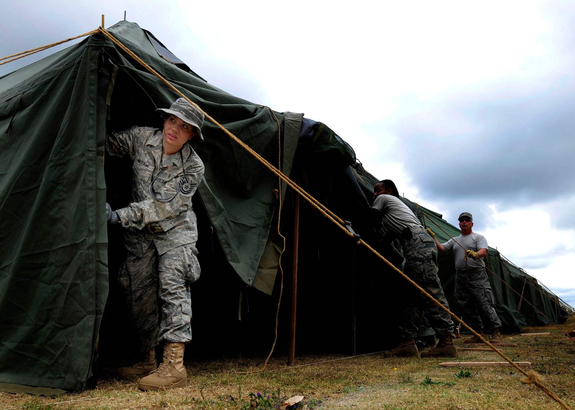 Tech. Sgt. Nakisha Mataia supports a tent pole March 23, 2010, in Angol, Chile. The hospital in Angol was severely damaged in an 8.8-magnitude earthquake Feb. 27, 2010. With the loss of the regional hospital, local medical officials lost the use of 190 beds. At the request of the Chilean government officials, an Air Force Expeditionary Medical Support team deployed to Angol to build a hospital to serve the more than 110,000 people in the region. Sergeant Mataia is an aerospace medical technician assigned to the 56th Medical Group at Luke Air Force Base, Ariz. (U.S. Air Force photo/Senior Airman Tiffany Trojca)