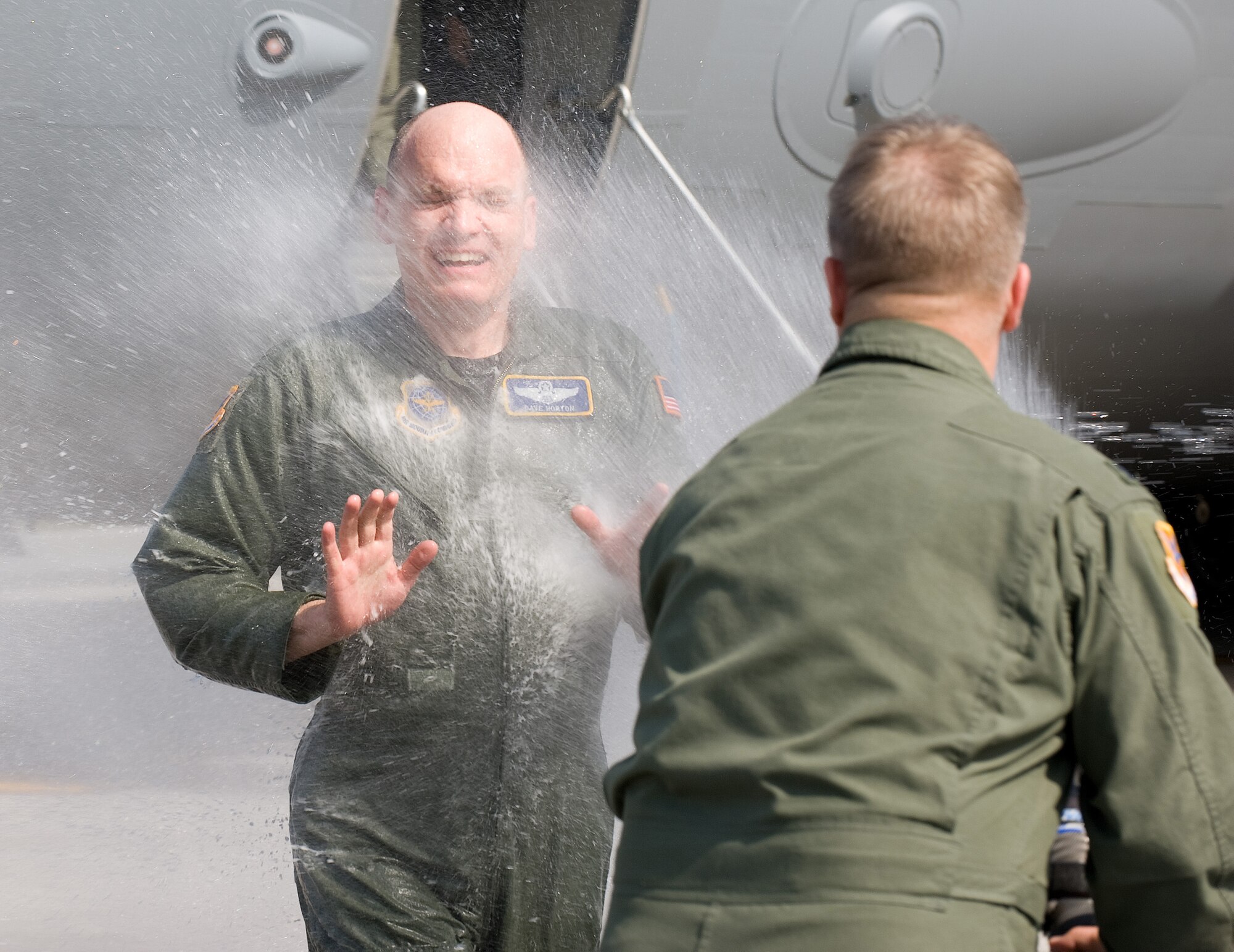 Col. David Horton, 436th Operations Group commander, is sprayed with water after his last flight at Dover Air Force Base by Col. David Hafer, 436th OG.  Colonel Hafer took command of the 436th OG during a Change of Command ceremony March 25.  (U.S. Air Force photo/Jason Minto)