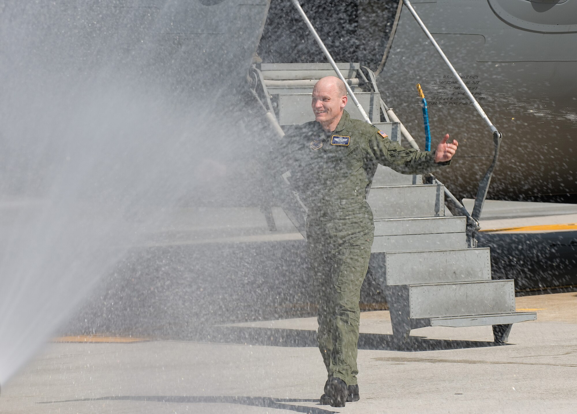 Col. David Horton, 436th Operations Group commander, is sprayed with water after his last flight at Dover Air Force Base March 25.  Colonel Horton relinquished command of the 436th OG to Col. David Hafer during a Change of Command ceremony March 25.  (U.S. Air Force photo/Jason Minto)