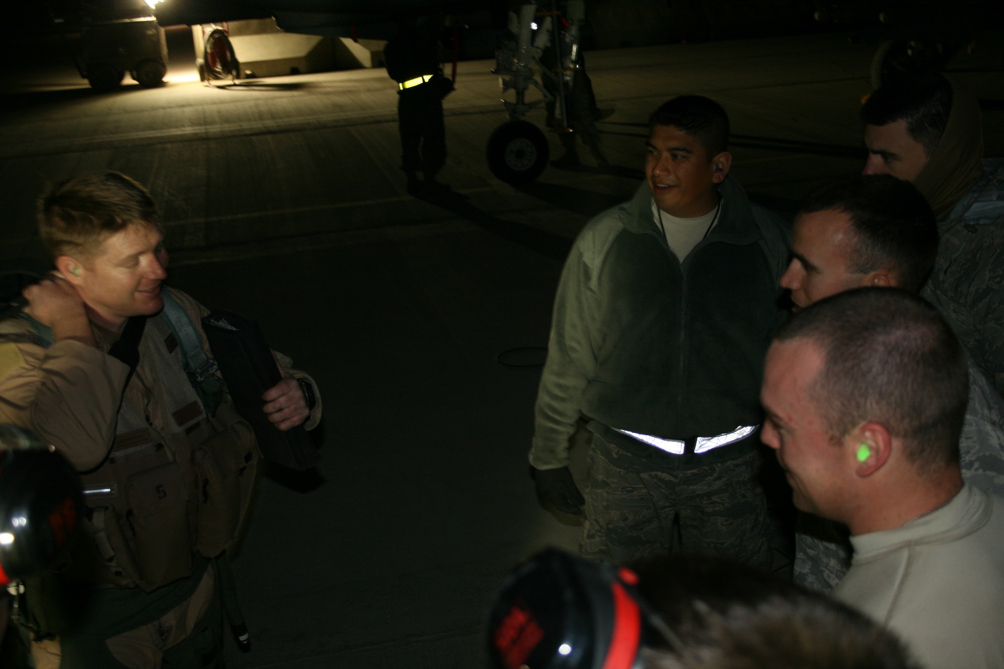 An A-10C pilot with the 104th Expeditionary Fighter Squadron based at Kandahar Airfield, Afghanistan, discusses a successful mission with the maintenance team responsible for his plane. (U.S. Air Force photo by David Speicher/Released)