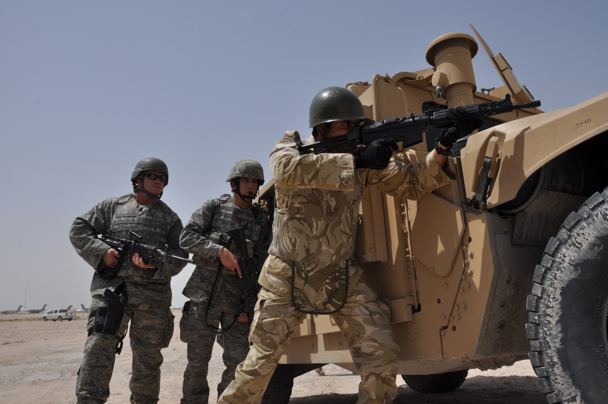 A host-nation member stands ready while members from the 379th Expeditionary Security Forces Squadron members prepare to respond to an exercise scenario at a non-disclosed Southwest Asia location March 23, 2010. (U.S. Air Force photo by Senior Airman Kasey Zickmund)[RELEASED]