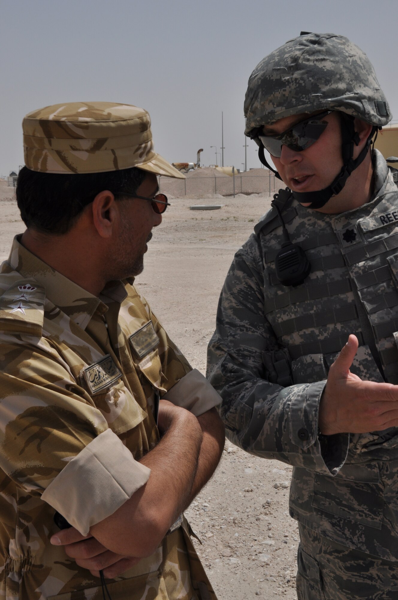 Col. Hassan Mubarak Al-Ghareeb, Host-Base security commander, and Lt. Col. Gregory Reese, 379th Expeditionary Security Forces Squadron commander, discuss the exercise scenario taking place at a non-disclosed Southwest Asia location March 23, 2010. (U.S. Air Force photo by Capt. Patrick Cordova)[RELEASED]