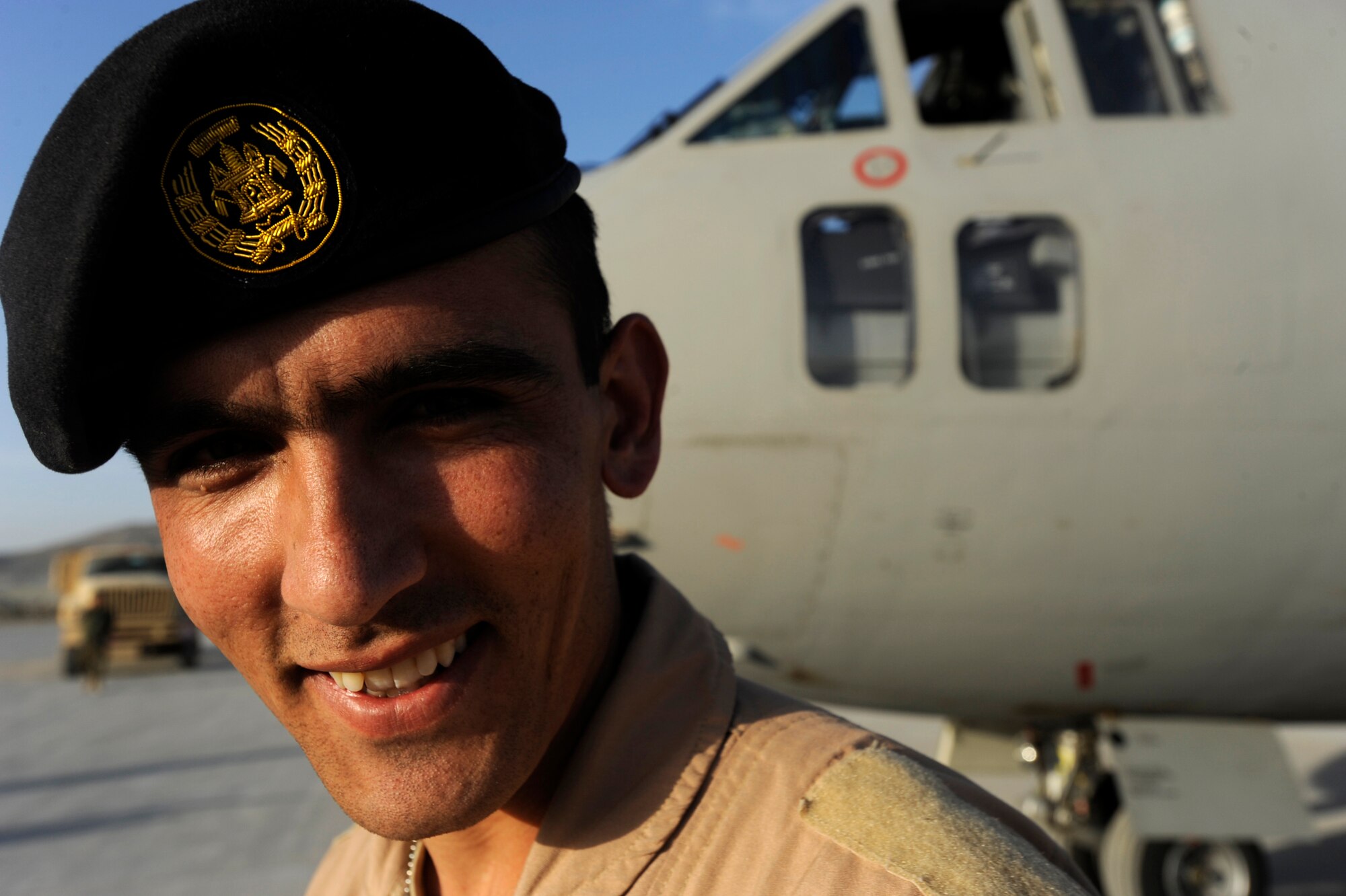 First Lieutenant Faiz M. Ramaki, a Afghanistan National Army Air Corps (ANAAC) C-27 pilot, smiles for a photo after flying a successful first operational mission,  March 24, 2010, at Kabul  International Airport, Afghanistan. "This mission shows the ability of our instructors, show the ability of us as Afghans and shows you what hard work can do," said Lieutenant Ramaki, who is also the first Afghan pilot to graduate from the nine-month U.S. pilot training course in more than 50 years. "We can now assist our brothers in combat and that means a lot. We are flying missions with meaning and purpose and I could not be happier."  (U.S. Air Force photo/Staff Sgt. Manuel J. Martinez/released)

