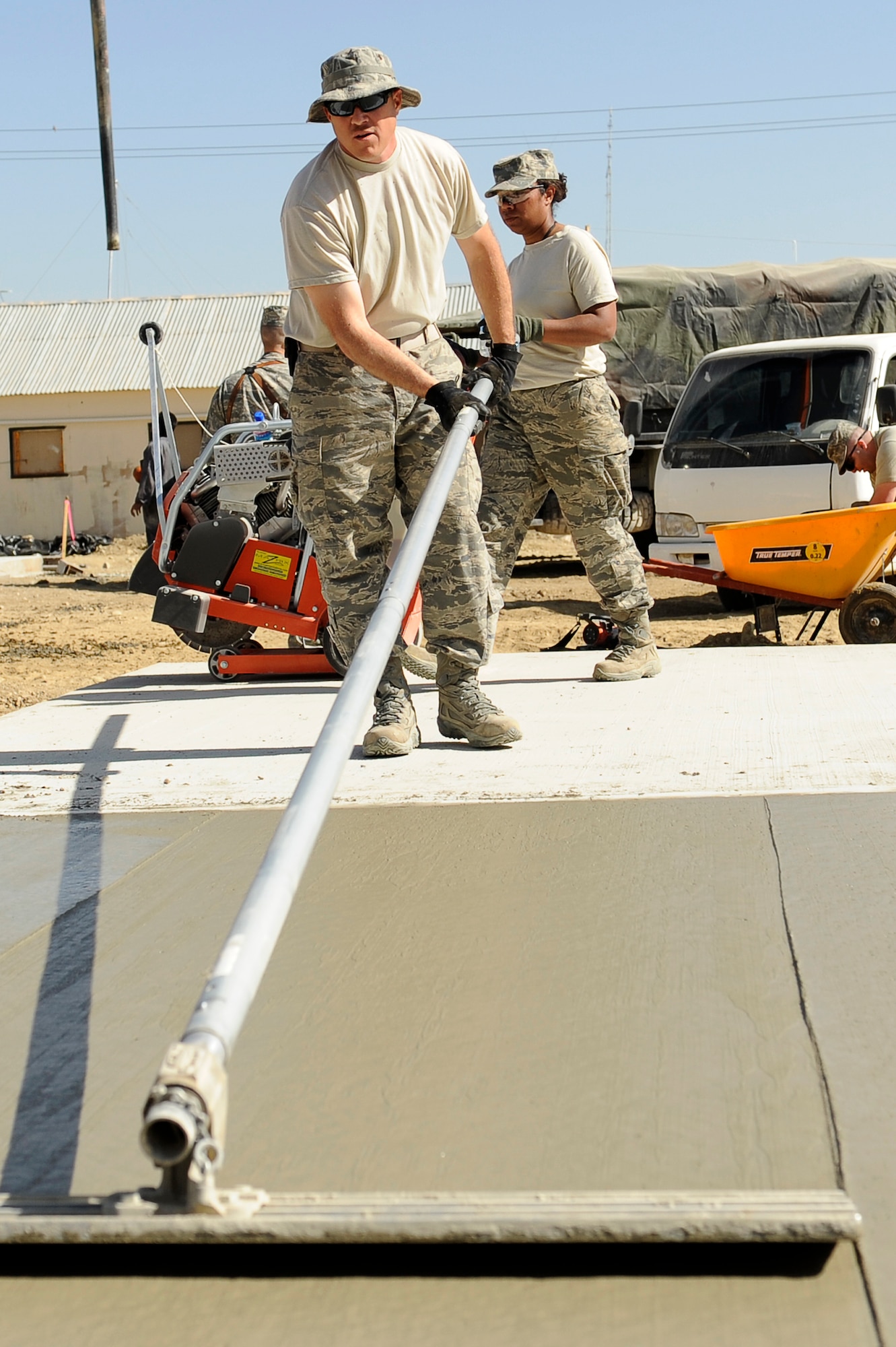 U.S. Air Force Tech. Sgt. Philip Deckard 577th Expeditionary Prime BEEF Squadron smoothes out a cement pad at Bagram Airfield, Afghanistan, March 24, 2010. Sergeant Deckard is deployed from Grisson Air Reserve Base, Ind., and is from Kokomo, Ind. (U.S. Air Force photo by/ Tech. Sgt. Jeromy K. Cross/released)





