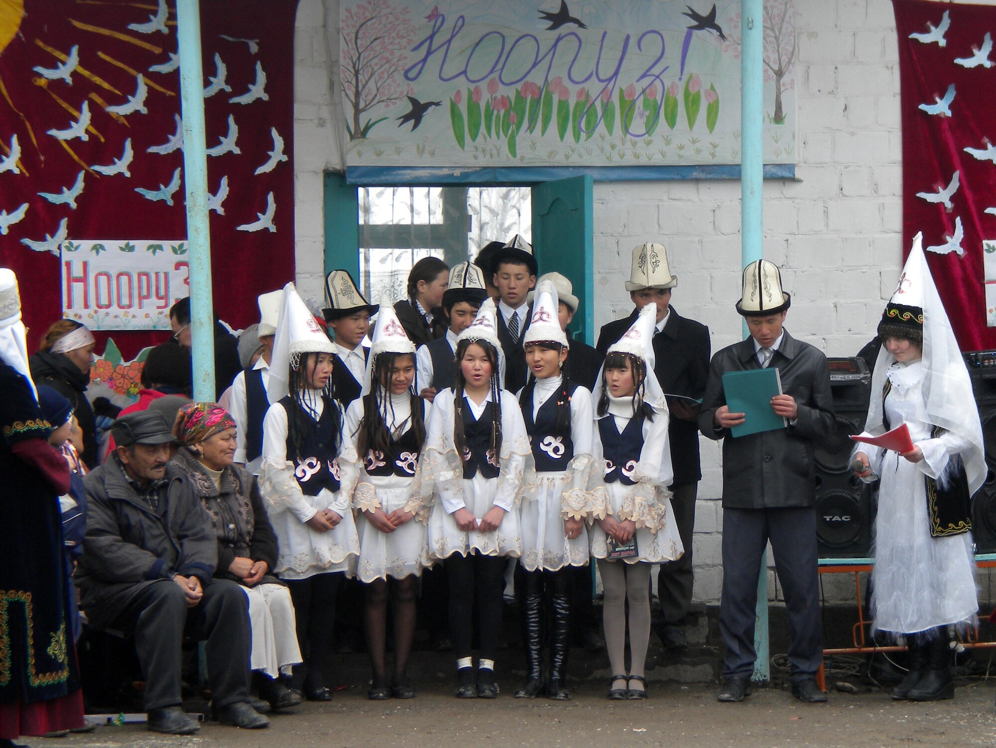 Students of Tor-Kul School singing in celebration of Nooruz, a spring holiday in Kyrgyzstan, during a visit Col. Blaine Holt, director of the Transit Center of Manas, made to the Tur-kul Village March 21, 2010. (U.S. Air Force photo/Chief Master Sgt. James Dowell/released)