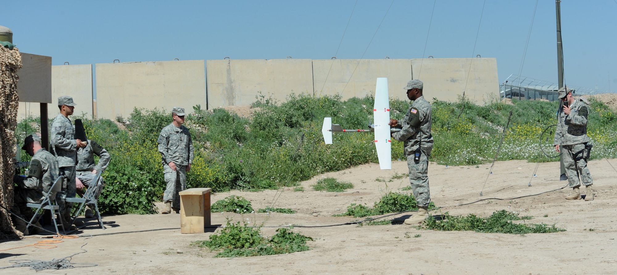 An operations check is done on a Raven-B unmanned aerial vehicle (UAV) by members of the 506th Expeditionary Security Forces Raven-B UAV team, before its launch at Kirkuk Regional Air Base, Iraq on March 23, 2010.  Raven-B is remotely piloted by a mission operator and vehicle operator who work side by side to coordinate on what they are seeing and what direction the device is flying. (U.S. Air Force photo/Staff Sgt. Tabitha Kuykendall/Released)